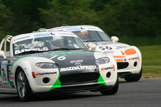 Jim Daniels (front) barely leads Todd Buras during Monday’s MX-5 Cup race at Lime Rock Park.